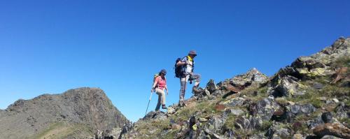 two people standing on the top of a mountain at Cal Sams in Olopte