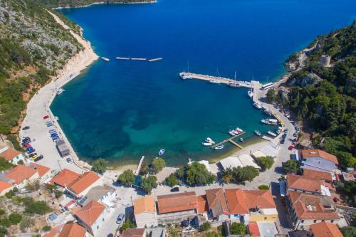 an aerial view of a bay with a dock at Cavos Seaside House in Vathi, Ithaka
