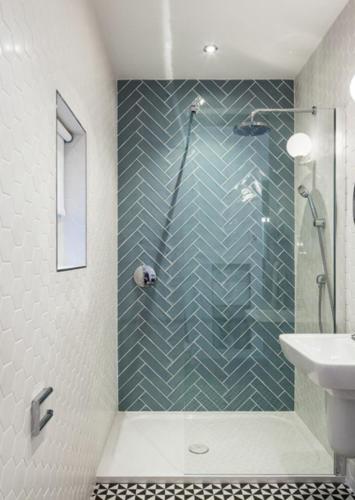 a bathroom with a shower and a toilet and a sink at Boherbui Cottage on the Wild Atlantic Way in Doolin
