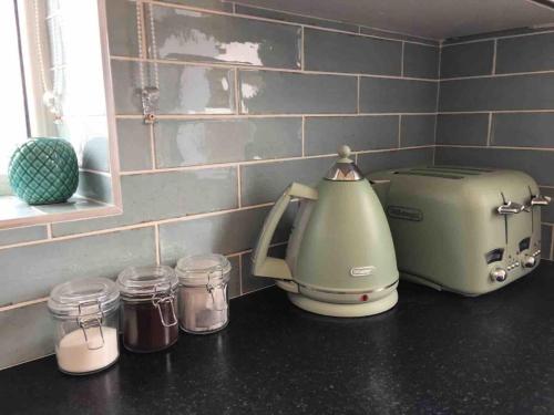 a kitchen counter with a toaster and jars on it at Boherbui Cottage on the Wild Atlantic Way in Doolin