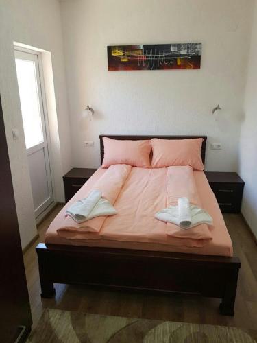 a bedroom with a bed with two towels on it at Apartmani Srećko in Žabljak
