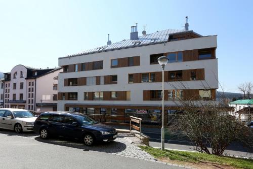 a black car parked in front of a building at Apartment Klostermann 006 in Železná Ruda