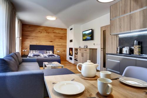 a living room with a blue couch and a table at Apartment Klostermann 006 in Železná Ruda