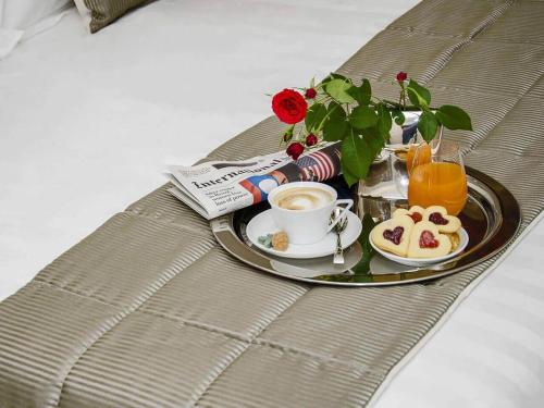 a tray with a plate of food and a cup of coffee at B&B WELLNESS Junior Suite CAREN in Grinzane Cavour