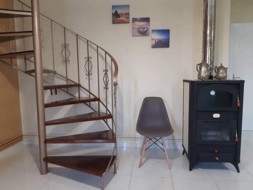 a staircase in a room with a chair and a desk at Anatoli View in Agia Marina Nea Kydonias