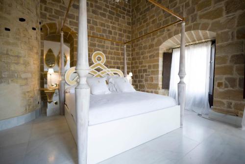 Una cama o camas en una habitación de Hotel Palacio De Úbeda 5 G.L