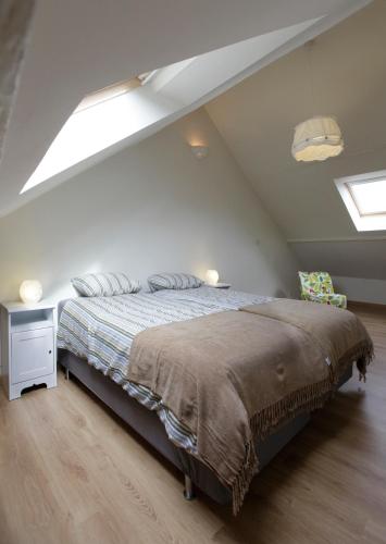 a bedroom with a bed in a attic at Aux Herbes Folles in Herve