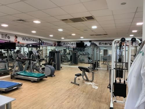 a gym with several treadmills and exercise machines at Different Atmosphere Suite in Caesarea