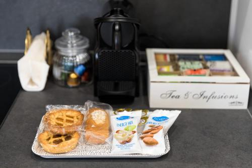a table with a plate of waffles and a box of food at San Zaccaria Apartment in Venice