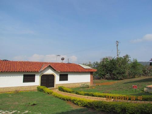 una casa bianca con tetto rosso di Condominio Parque Baviera a Barichara