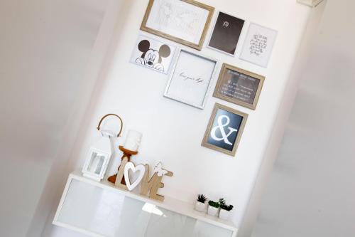 a white stairway with a shelf with various items on it at Holiday home Nina in Bol