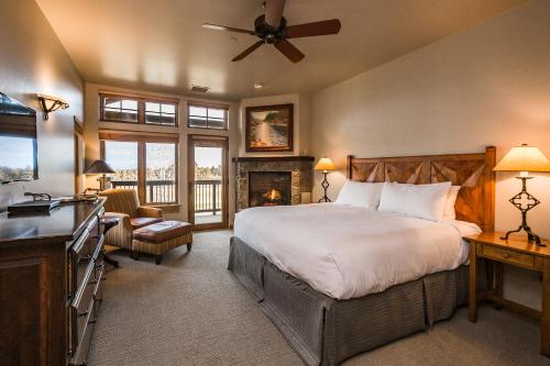 a bedroom with a large bed and a fireplace at Juniper Preserve in Redmond