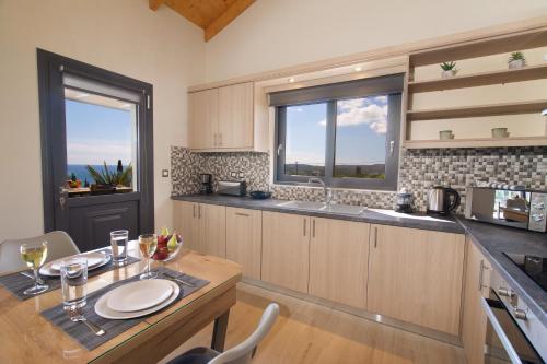 a kitchen with a wooden table and a dining room at Vista Blu Villa in Vlachata