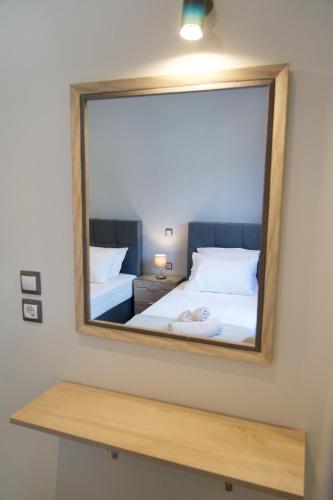 a mirror on a wall with a bed in a room at Vista Blu Villa in Vlachata