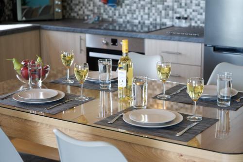 a table with glasses and a bottle of wine at Vista Blu Villa in Vlachata
