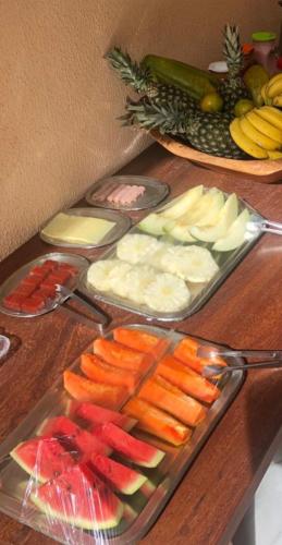 a wooden table with a tray of vegetables and fruits at Hotel Alta Vista in Canoa Quebrada