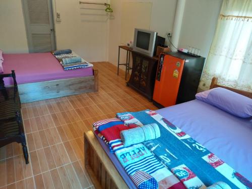 Postel nebo postele na pokoji v ubytování Baan Pak Phutawan Resort