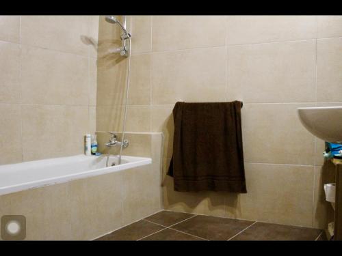 a bathroom with a bath tub and a sink at Amelia's House of Character in Cospicua