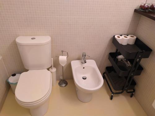 a bathroom with a white toilet and a bidet at Lisbon central apartment in Entrecampos in Lisbon