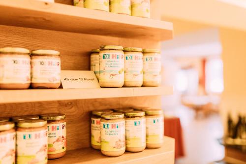 a shelf with jars of food on it at Pitzis Kinderhotel - Family Only in Arzl im Pitztal