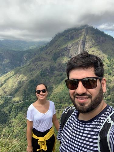 a man and a woman standing in front of a mountain at Home Away Ella in Ella
