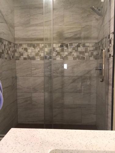 a shower with a glass door in a bathroom at Hamilton Inn Sturbridge in Sturbridge