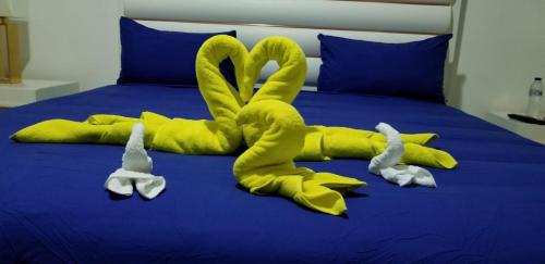 a bed with two swans made out of towels at Villa de Colores 3 Rooms 5 king Beds in Sosúa