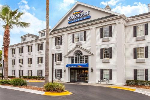 a white building with a sign on it at Baymont by Wyndham Jacksonville/Butler Blvd in Jacksonville