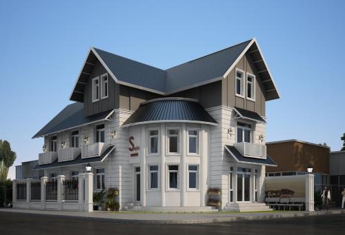 a large white building with a black roof at Sele House in Ha Tien