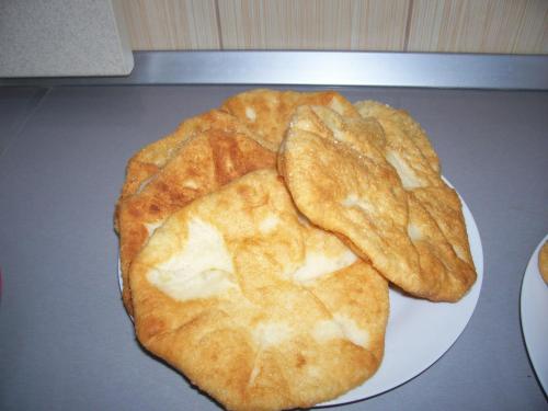 a plate of food with a pie on a table at Pensiunea Mara in Deseşti
