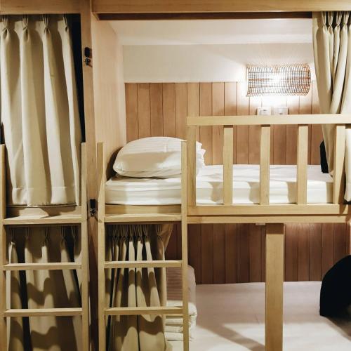 a room with two bunk beds and a bed at Amaka Bed and Breakfast in Chiang Mai