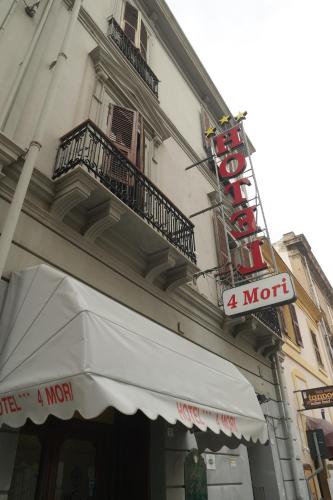 a store with a sign on the side of a building at Hotel 4 Mori in Cagliari