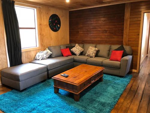 a living room with a couch and a coffee table at Mount Cook Station Shearers Quarters Lodge in Lake Tekapo