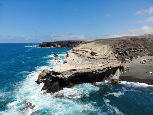 an aerial view of a rocky island in the ocean at Ajuy Tortuga House in Ajuy