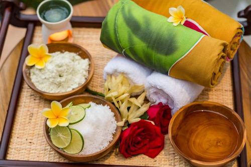 three bowls of rice and flowers on a table at The Pesaren Ubud in Ubud