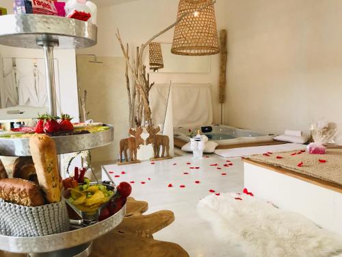 a living room with a table with food on the floor at Mas Sainte Marie ,Piscine Chauffée in Aigues-Mortes