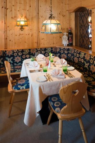 a table in a restaurant with a white table cloth at Biohotel Leutascherhof in Leutasch