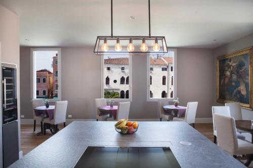 a dining room with a table with a bowl of fruit on it at Palazzetto Foscari in Venice