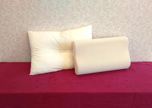 a white pillow sitting on top of a bed at Hotel New Century Sakaide in Sakaide
