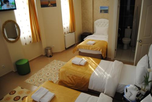a hotel room with two beds and a bathroom at Lotus Hotel in Istanbul
