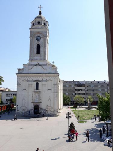 a large white church with a clock tower at Prenociste Nikolas Grand in Smederevo