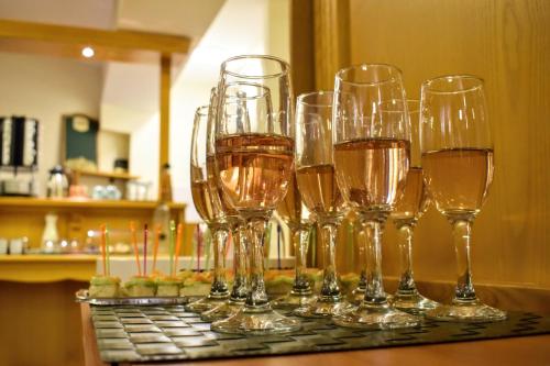 a group of wine glasses sitting on a table at Vila Seva in Vatra Dornei
