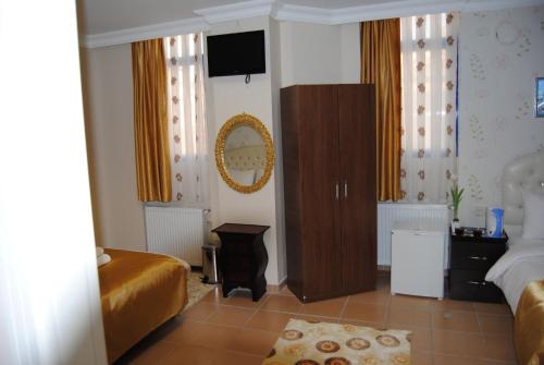 a bedroom with two beds and a television on the wall at Lotus Hotel in Istanbul