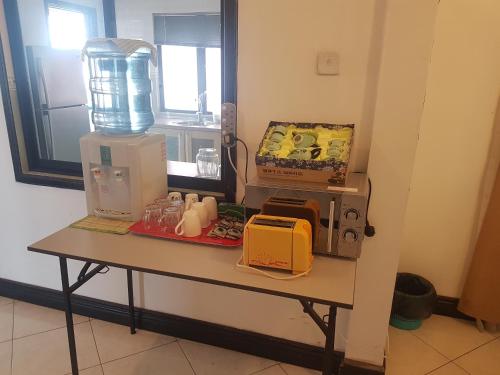 a table with a blender and other items on it at Peter Holiday Home @ Marina Court Condo in Kota Kinabalu