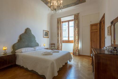 a bedroom with a large bed and a window at The Suite Dome Apartment by Mamo Florence in Florence