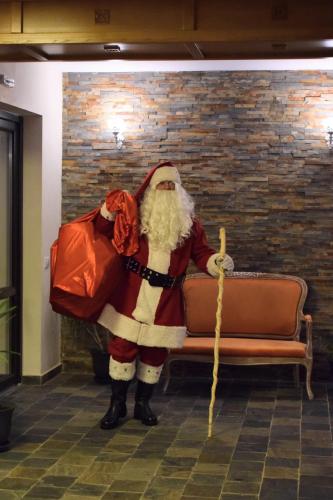 a man dressed as santa sitting on a couch at Vila Seva in Vatra Dornei