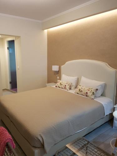 a bedroom with a large bed with two pillows at Angels Pool Studios and Apartments in Paleokastritsa