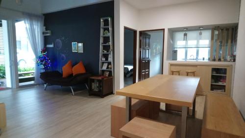 a living room with a dining table and a christmas tree at 758 Residence in Miri