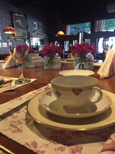 a table with a tea cup and plates on it at Hotel City Bell in La Plata