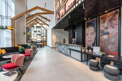 a lobby with tables and chairs and a bar at Studio One Hotel in Dubai